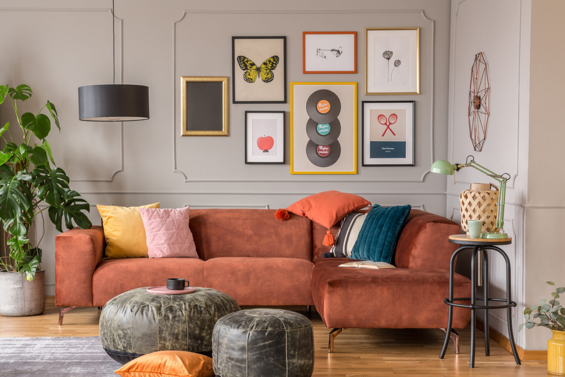 vintage black poufs in trendy eclectic living room interior with brown couch